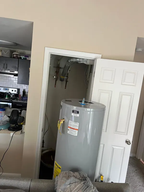 Water heater in a utility closet with copper supply connections